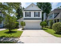 Charming two-story home with a two-car garage, landscaped yard, and inviting curb appeal at 1813 Parkland Preserve Ln, Charleston, SC 29412