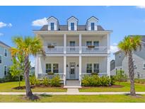Charming two-story home with a double porch and lush landscaping at 1828 Agate Bay Dr, Mount Pleasant, SC 29466