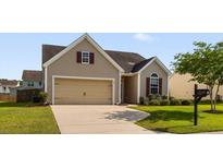 Charming single-Gathering home showcasing a manicured lawn, a driveway, and a two-car garage at 183 Cypress Forest Dr, Moncks Corner, SC 29461