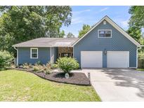Charming home with a two-car garage, landscaped front yard and beautiful lawn at 211 White Church Ln, Summerville, SC 29485