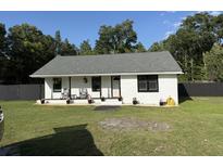 Charming home with inviting front porch, beautiful landscaping, and well-maintained lawn at 304 Carolina Cir, Walterboro, SC 29488