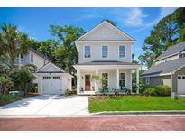 Charming two-story home with a well-manicured front yard and a detached garage at 3285 Johnstowne St, Johns Island, SC 29455