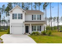 Charming two-story home with a well-manicured lawn and attached garage offers great curb appeal at 525 Purple Finch Rd, Summerville, SC 29486