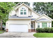 Charming two-story home featuring a two-car garage, a well-manicured lawn, and classic suburban curb appeal at 5359 Curtisston Ct, North Charleston, SC 29418