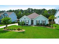 Charming single-story home with a well-manicured lawn, landscaping, and black shutters at 5509 Alpine Dr, Summerville, SC 29483