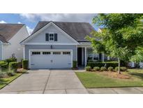 Charming home with a well-manicured front yard and an attached two-car garage at 105 Harbor Trace Ln, Summerville, SC 29486