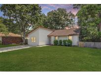 Charming one-story home featuring a green lawn, classic siding, and mature trees against a colorful sunset backdrop at 109 Salem Ct, Summerville, SC 29486