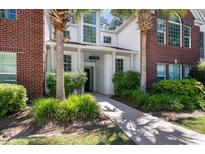 Charming condo with inviting entrance, lush landscaping, and classic brick accents at 115 Golfview Ln, Summerville, SC 29485