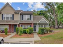Charming two-story townhome with well-maintained landscaping and inviting front entrance at 117 Macy Cir, Goose Creek, SC 29445