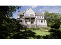 Charming two-story home featuring a welcoming front porch, landscaped yard, and classic architectural details at 117 Spartina Ct, Kiawah Island, SC 29455