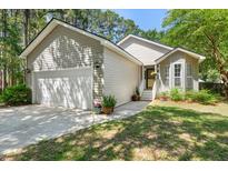 Charming single-Gathering home with attached garage and a well-maintained front yard at 1227 Ocean View Rd, Charleston, SC 29412