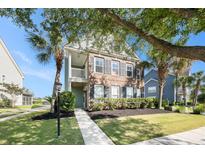 Charming two-story home with brick and siding, complemented by a landscaped front yard and a quaint second story balcony at 125 Gaslight Blvd, Summerville, SC 29483