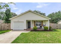 Charming single-story home featuring a welcoming front porch and a well-maintained front yard at 1302 Aubry Dr, Moncks Corner, SC 29461