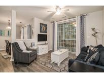 A well-decorated living room with modern furnishings and access to outdoor balcony at 1600 Long Grove Dr # 1512, Mount Pleasant, SC 29464