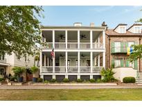 Stunning two-story home features a spacious double porch, complete with columns and ceiling fans at 18 Fernandina St, Mount Pleasant, SC 29464