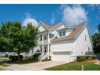 Charming two-story home with a white exterior, a two-car garage, and well-manicured landscaping at 2242 Dewees Creek Dr, Mount Pleasant, SC 29466