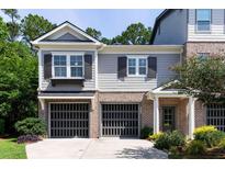 Charming townhome featuring brick accents, a two-car garage, and manicured landscaping for curb appeal at 225 Slipper Shell Ct, Mount Pleasant, SC 29464