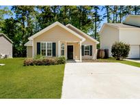 Charming one-story home with manicured lawn and inviting front entrance, complemented by lush surrounding greenery at 258 Trickle Dr, Summerville, SC 29483