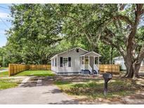 Charming single story home features a covered porch, fresh paint, mature trees, and a new fence at 2678 Ranger Dr, North Charleston, SC 29405