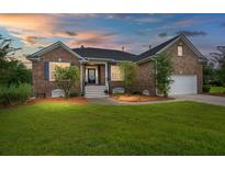 Charming brick home with manicured lawn, and a driveway leading to the attached garage in a well-lit setting at 2772 Latrobe Ct, Mount Pleasant, SC 29466