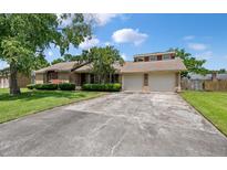 Charming one-story brick home with a two-car garage and a well-maintained lawn and mature landscaping at 2912 Doncaster Dr, Charleston, SC 29414