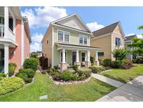 Charming two-story home with inviting front porch and landscaped yard, enhancing curb appeal at 3046 Sweetleaf Ln, Johns Island, SC 29455