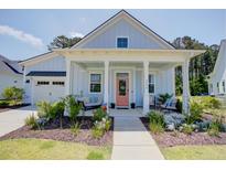 Charming home featuring a quaint covered porch with stylish seating and a well-manicured front yard at 3539 Habenaria Rd # 28, Mount Pleasant, SC 29466