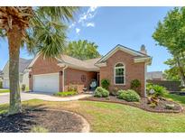 Charming brick home with a manicured lawn, a palm tree, and a cozy front porch display at 422 Cabrill Dr, Charleston, SC 29414