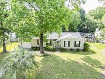Charming single-story home with a well-manicured lawn and mature trees offering curb appeal at 5 Drummond Ct, Charleston, SC 29414