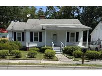 Charming bungalow with a well-manicured lawn and inviting front porch swing at 505 Blacks St, Walterboro, SC 29488