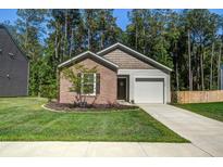 Charming single-story home featuring a brick facade, a one-car garage, and a well-manicured lawn at 510 Shady Maple St, Moncks Corner, SC 29461