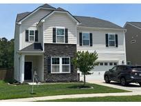 Charming two-story home with a combination of stone and siding exterior and manicured front yard at 677 Redbud Ln, Summerville, SC 29486