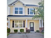 Charming two-story home featuring a welcoming front porch and well-maintained landscaping at 9088 Parlor Dr, Ladson, SC 29456