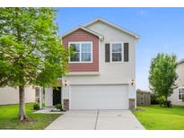 Charming two-story home with white siding, brick accents, and an attached two car garage at 9747 Seed St, Ladson, SC 29456