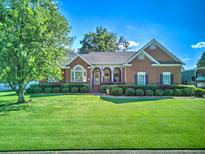 Charming brick home with a manicured lawn and lush landscaping, perfect for curb appeal at 1111 Ole South Ct, Moncks Corner, SC 29461