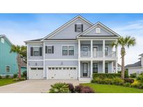 Charming two-story home with a double porch, three-car garage, manicured lawn, and mature palm trees at 1234 Captain Rivers Dr, Charleston, SC 29412