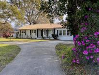Charming one-story home with a copper roof and well-maintained lawn at 1329 Camp Rd, Charleston, SC 29412