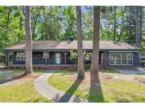 Charming single story home with brick foundation, porch, and mature trees at 205 Woodlawn St, Walterboro, SC 29488