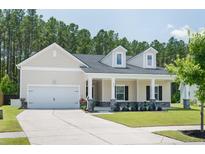 Charming home featuring a two-car garage, a covered porch, and a well-manicured lawn at 209 Country Gate Ln, Summerville, SC 29485
