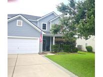 Charming two-story home with gray siding, white trim, a well-manicured lawn, and an attached two-car garage at 216 Goldfinch Ln, Summerville, SC 29485