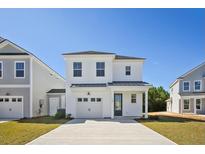 Charming two-story home featuring a single-car garage, a welcoming front porch, and a well-manicured front yard at 350 Chapman Cir, Goose Creek, SC 29445