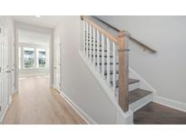 Bright foyer features a staircase with white risers, wooden treads, and a wooden handrail at 352 Chapman Cir, Goose Creek, SC 29445
