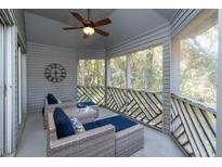 Relax on this screened-in porch with seating and wooded views at 5504 Green Dolphin Way, Kiawah Island, SC 29455