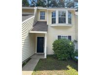 Inviting two-story home with neutral siding, complemented by mulled windows and well-maintained landscaping at 6 Town Park Ln # C, Charleston, SC 29412