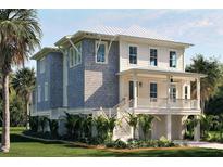 Charming coastal home with a metal roof, a welcoming front porch, and well-maintained landscaping at 8266 Jack Island Dr, Johns Island, SC 29455