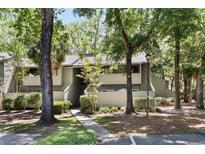 Inviting exterior of a condo with mature trees and green space, offering a serene and picturesque setting at 1195 Village Creek Ln # 2, Mount Pleasant, SC 29464
