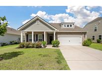 Charming single-story home with brick accents, landscaped yard, and attached two-car garage at 143 Daniels Creek Cir, Goose Creek, SC 29445