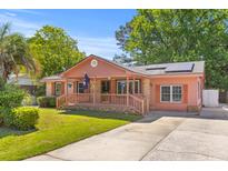 Charming single-story home featuring a welcoming front porch and well-maintained lawn at 1593 Westwood Dr, Charleston, SC 29412