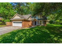 Charming two-story brick home with a well-manicured lawn and attached two car garage at 2650 Summer Leaves Ct, Charleston, SC 29414