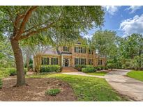 Traditional two-story brick home with black shutters, lovely landscaping, and inviting curb appeal at 3331 Cottonfield Dr, Mount Pleasant, SC 29466